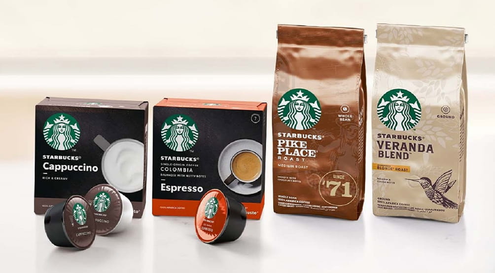 Quatro embalagens de cafés Starbucks, sendo cappuccino, espresso, Pike place e Veranda blend.